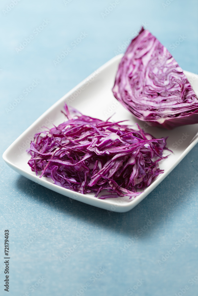 Shredded red cabbage on white plate Shredded red cabbage on white plate