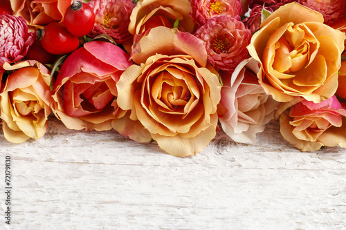 Pastel pink roses on wooden background