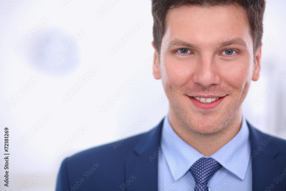 Business man or manager standing against his desk at the office Business man or manager standing against his desk at the office