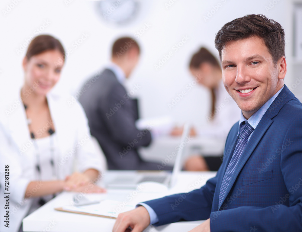 Beautiful young business people with colleagues discussing in Beautiful young business people with colleagues discussing in