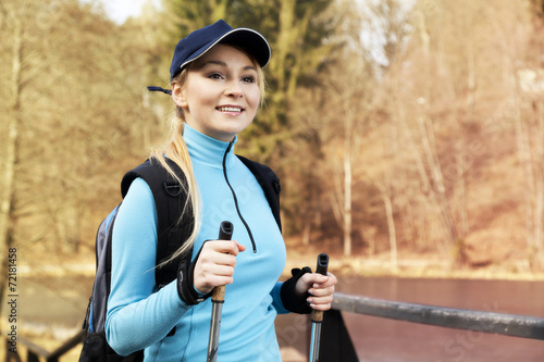 Closeup of young woman with Nordic walking poles