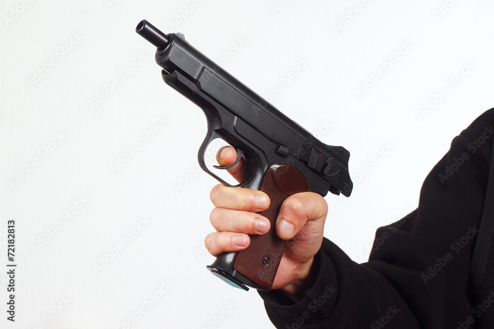 Hand with discharged semi-automatic pistol on a white background Hand with discharged semi-automatic pistol on a white background