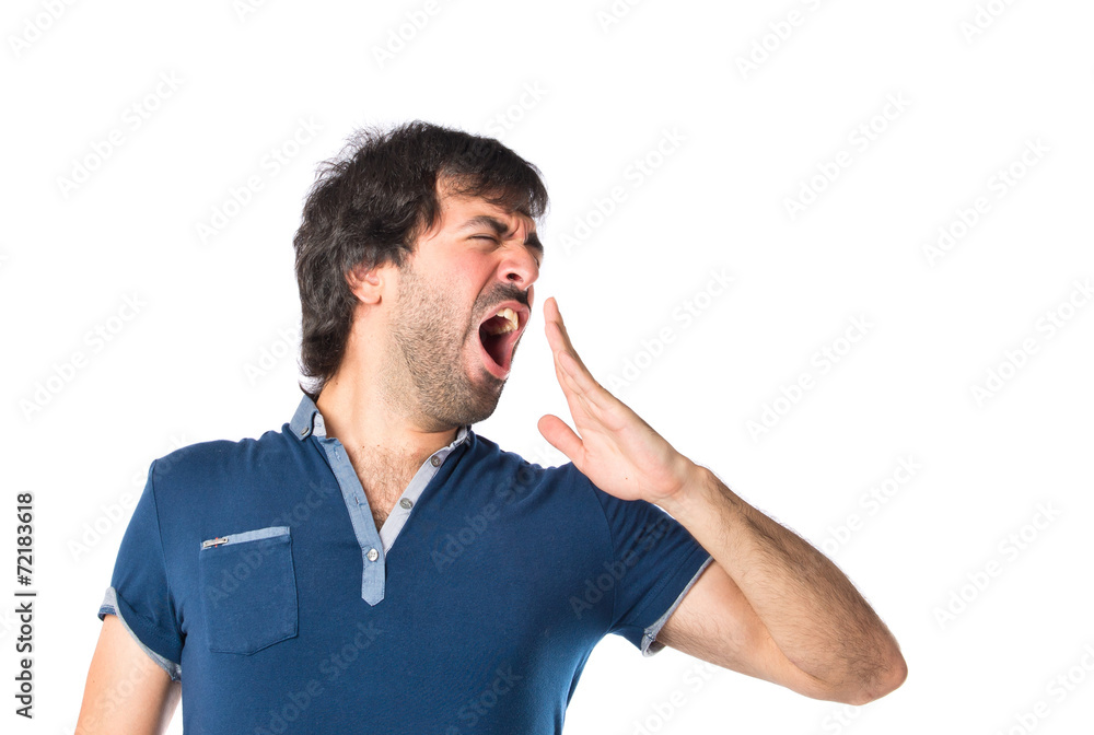 Man yawning over isolated white background Man yawning over isolated white background