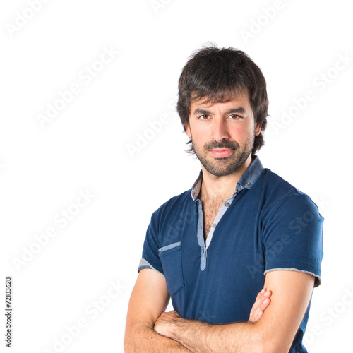 Man with his arms crossed over white background © luismolinero
