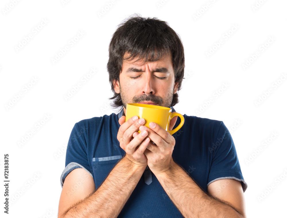 Man holding a cup of coffee over white background Man holding a cup of coffee over white background
