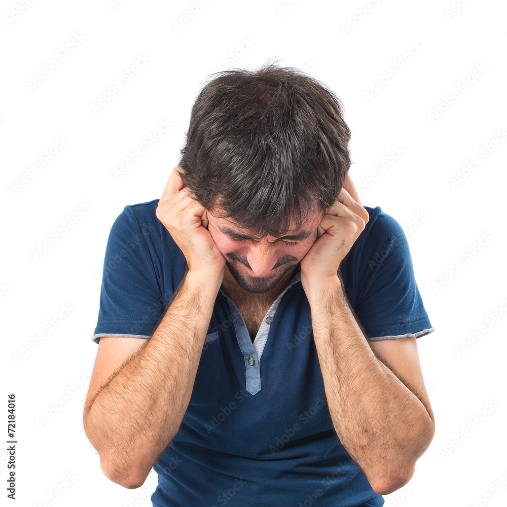 Man covering his ears over white background Man covering his ears over white background
