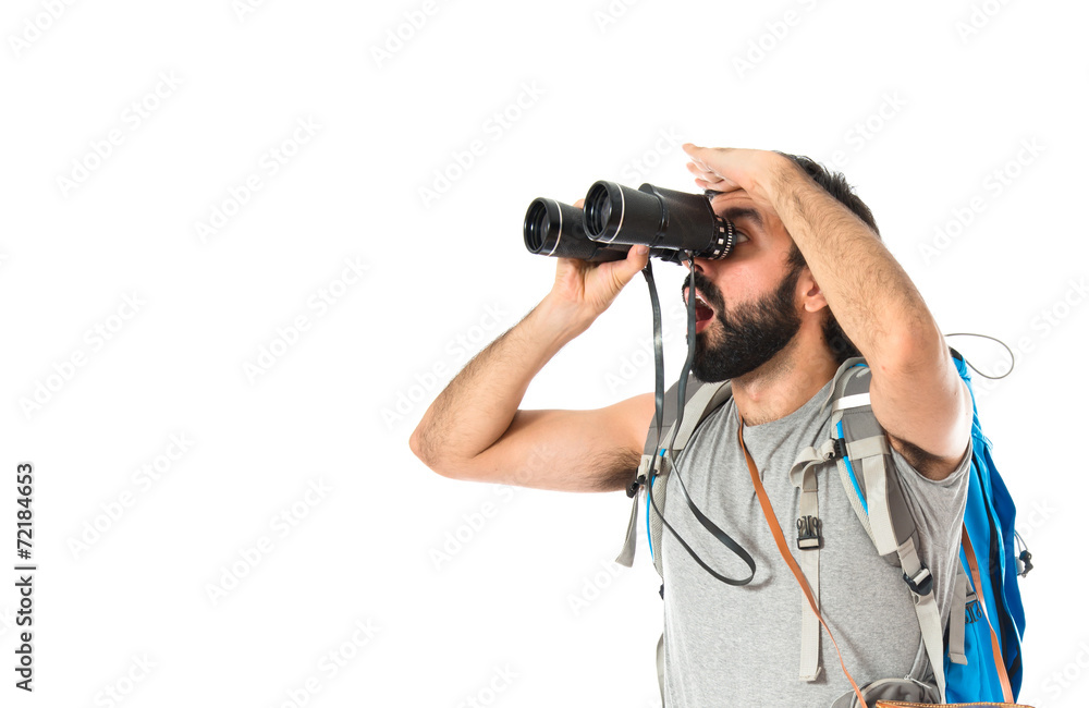 Backpacker with binoculars over isolated white background Backpacker with binoculars over isolated white background