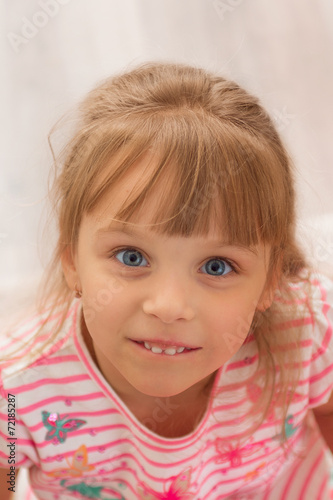 Cute little girl at home. Close-up portrait. © tananddda