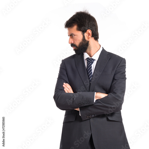 Businessman with his arms crossed over white background