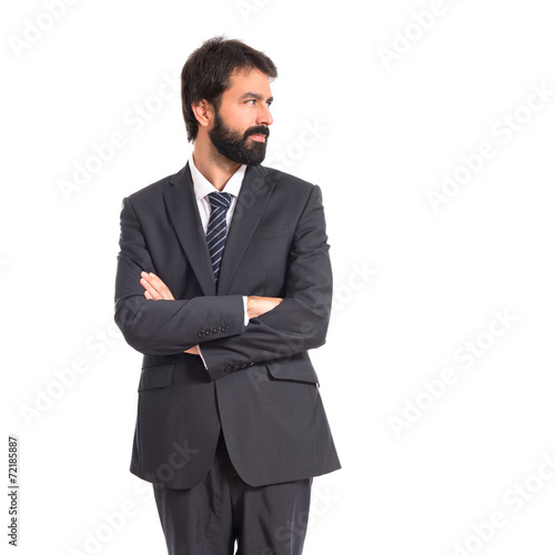 Businessman with his arms crossed over white background