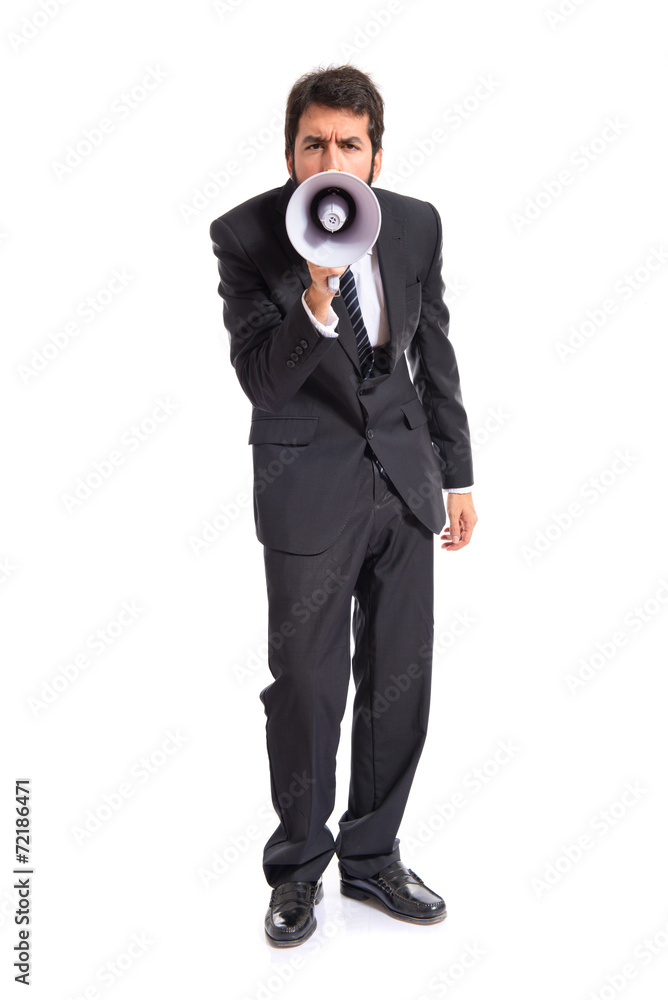 Businessman shouting by megaphone over white background Businessman shouting by megaphone over white background