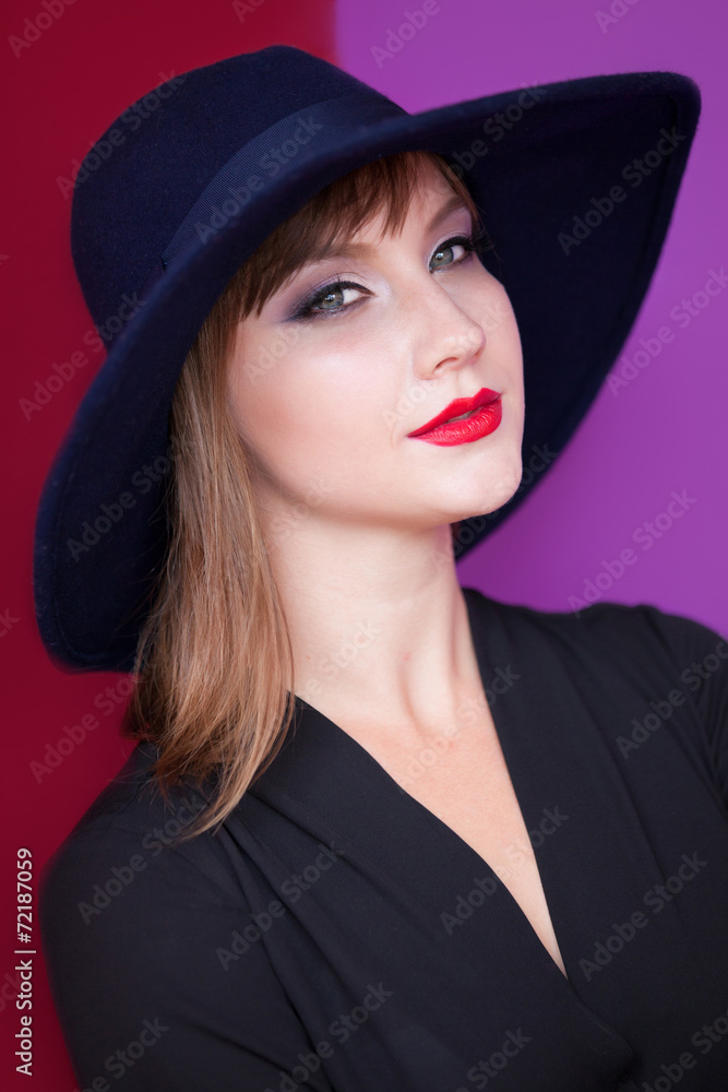 Brunette girl with hat on red and violet background. Brunette girl with hat on red and violet background.