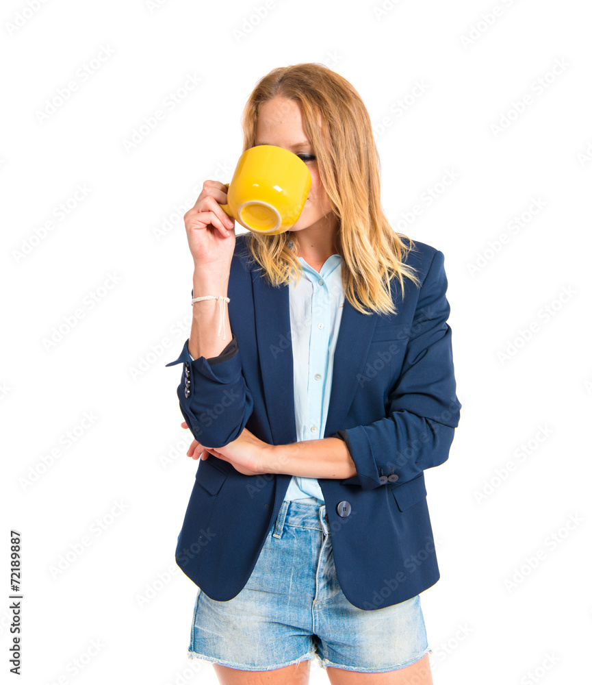 Blonde girl drinking coffee over white background Blonde girl drinking coffee over white background