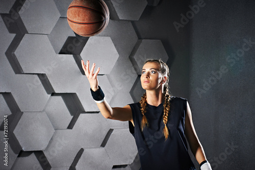 Active playing girl with a basketball photo