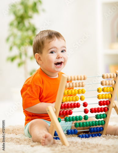 kid boy playing with abacus