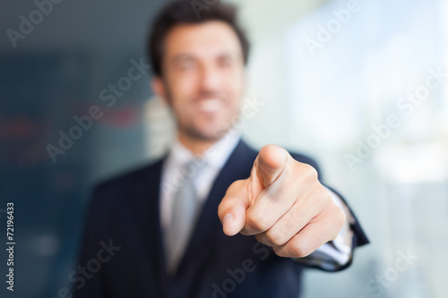 Businessman pointing his finger at you