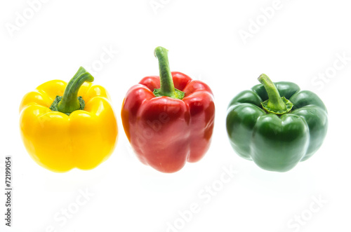 Red,green and yellow bell peppers on white background