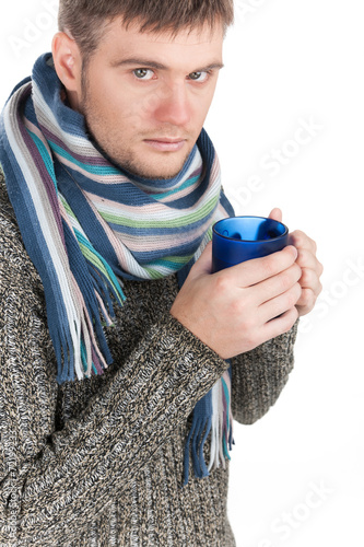 Portrait of sick man holding cup of tea.