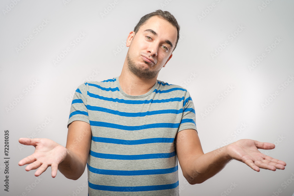 Young man throws up his hands in surprise Young man throws up his hands in surprise
