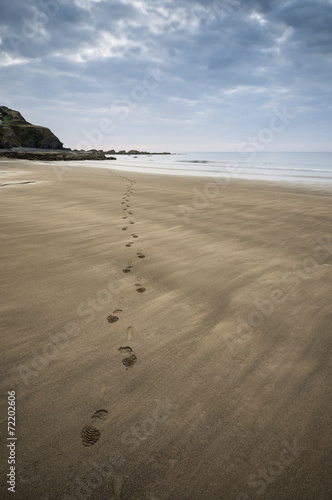 Footprints on beach Summer sunset landscape