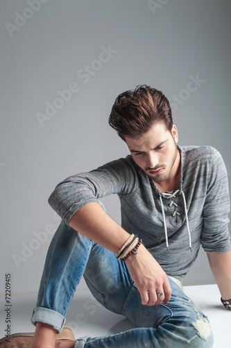 young fashion man looking down while relaxing © Viorel Sima