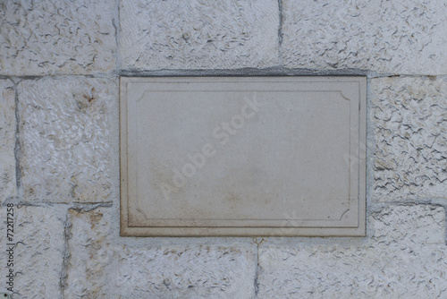 Blank board on the stone wall