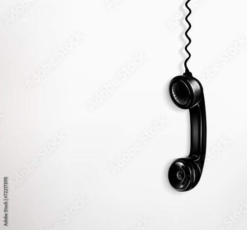 Black hanging telephone receivers on a white background.