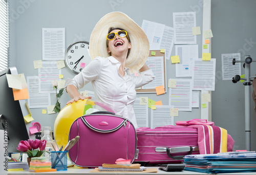 Cheerful employee leaving for vacations photo