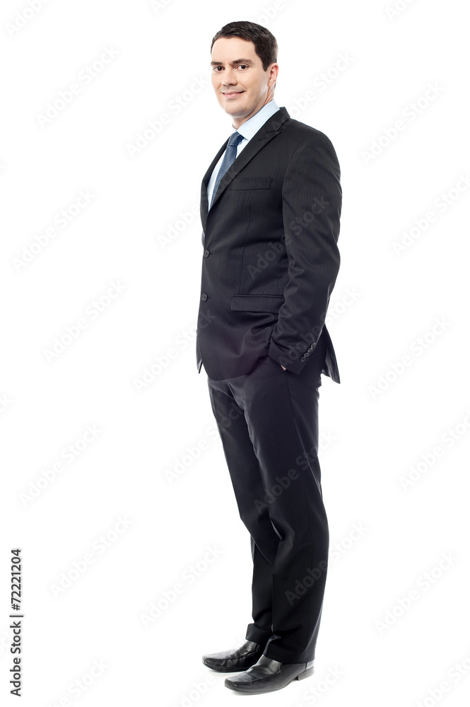 Confident businessman with hands in pockets Confident businessman with hands in pockets