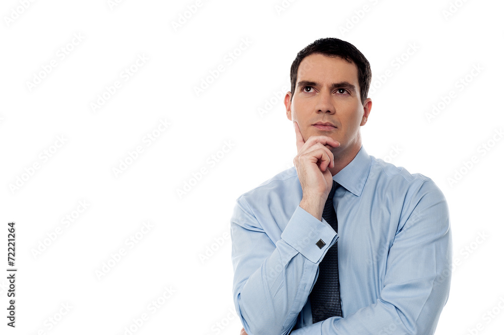 Thoughtful middle aged business man looking up Thoughtful middle aged business man looking up