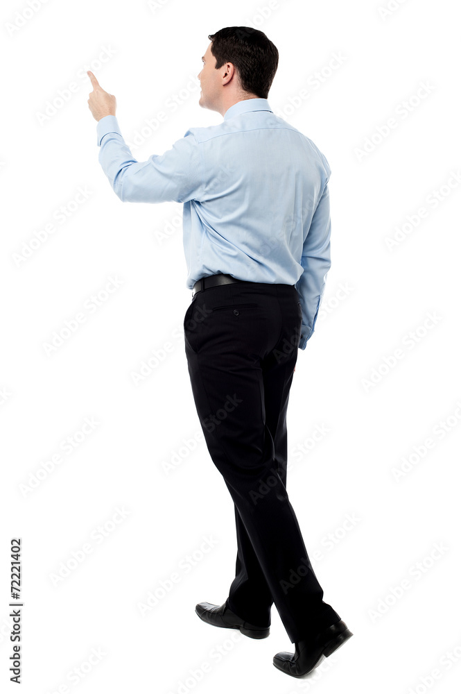 Back view of a middle aged man pointing finger Back view of a middle aged man pointing finger
