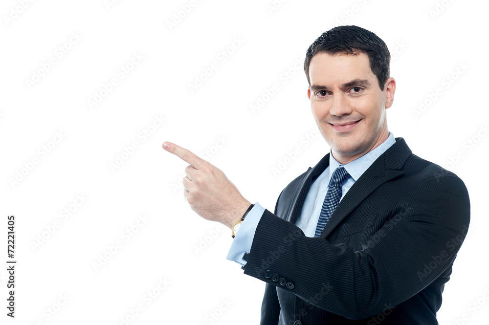 Smiling businesman pointing at something Smiling businesman pointing at something