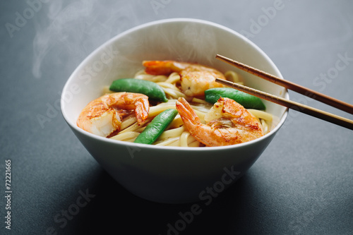 hot noodles with shrimps on a black background