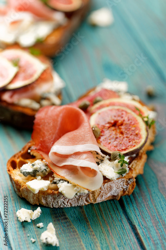 Grilled country bread with ham, blue cheese,  fig and capers