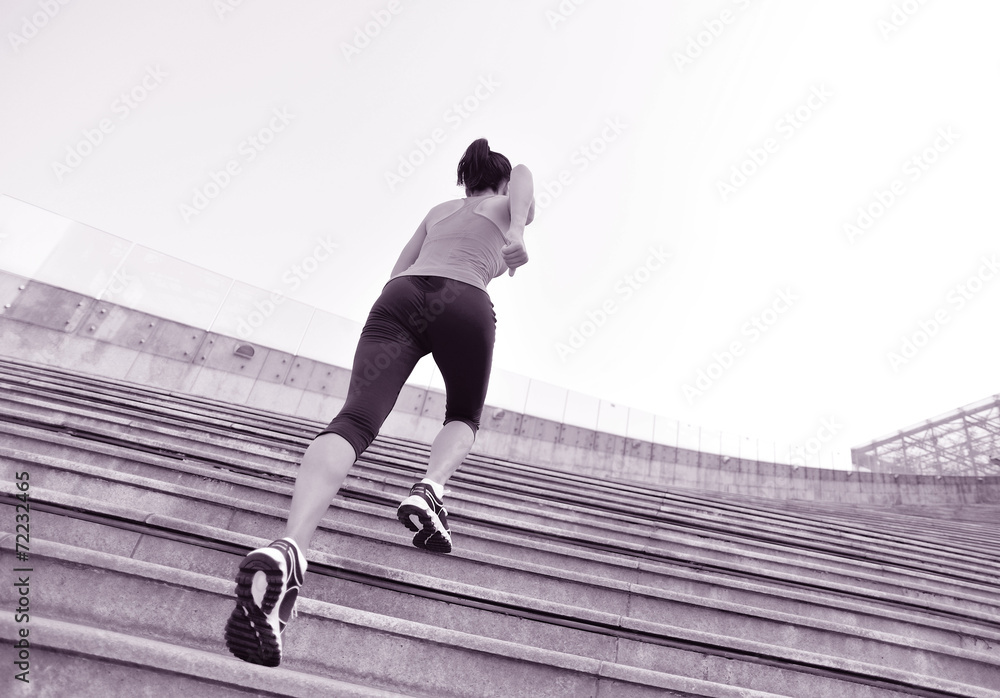 young fitness woman running up on stairs  