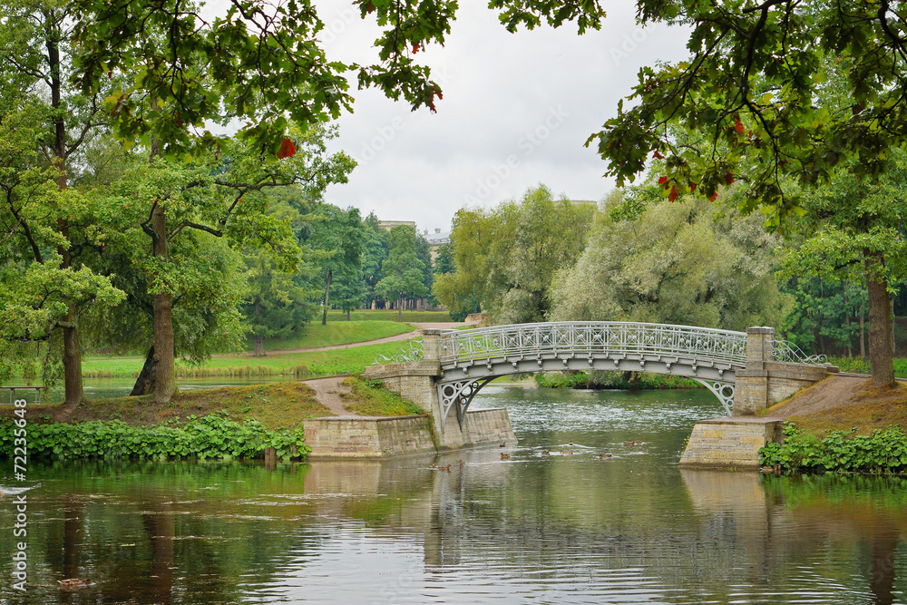 Metal bridge over flow in the palace park in Gatchina Metal bridge over flow in the palace park in Gatchina