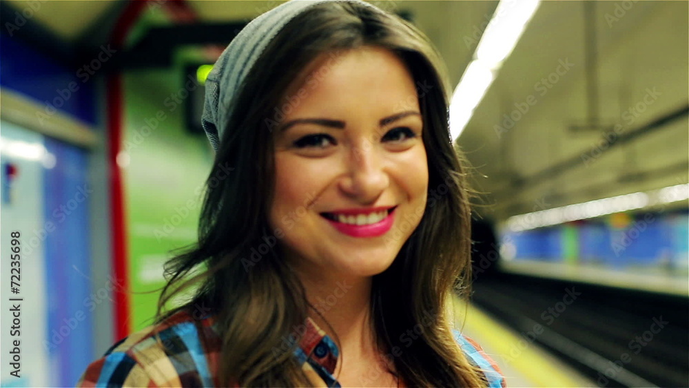 Happy woman smiling to the camera at metro station, steadycam Happy woman smiling to the camera at metro station, steadycam