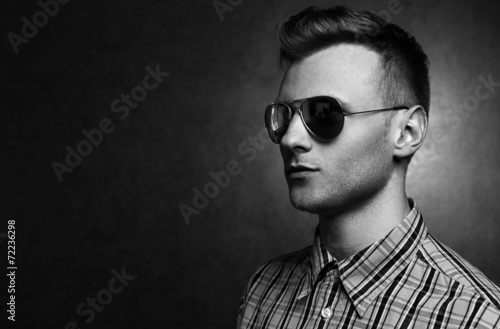 Сloseup portrait of a young casual man looking away from the ca © elainenadiv