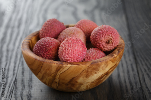 ripe lychees in wood bowl