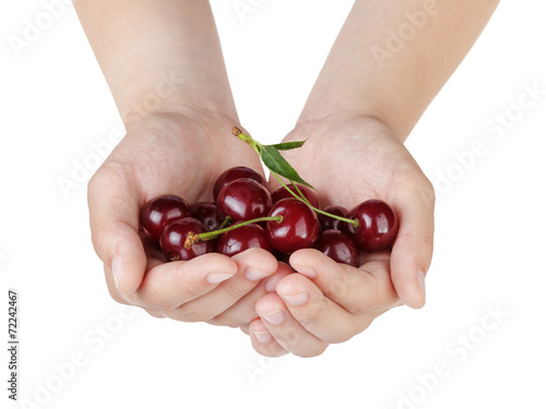 female teen hands holds cherries