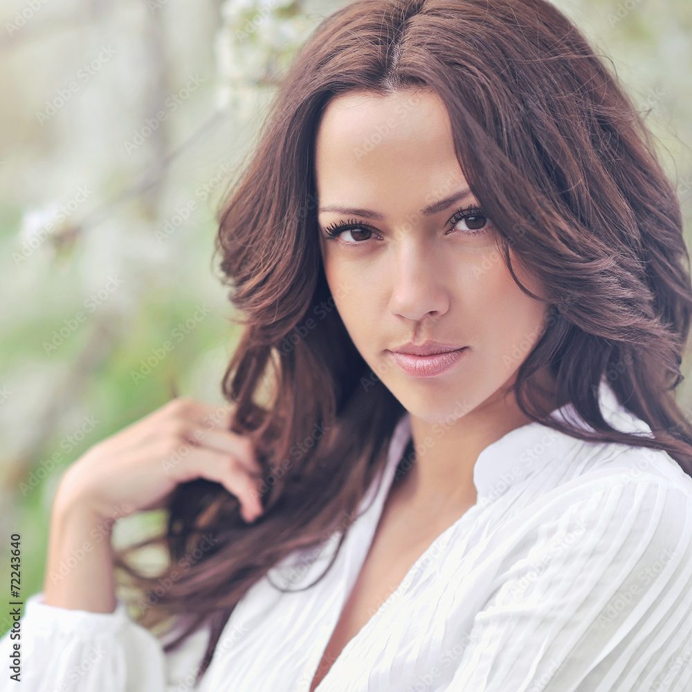 Fototapeta premium Young beautiful smiling woman outdoors
