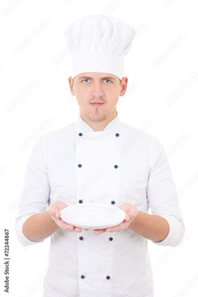 young man chef in uniform showing empty plate isolated on white young man chef in uniform showing empty plate isolated on white