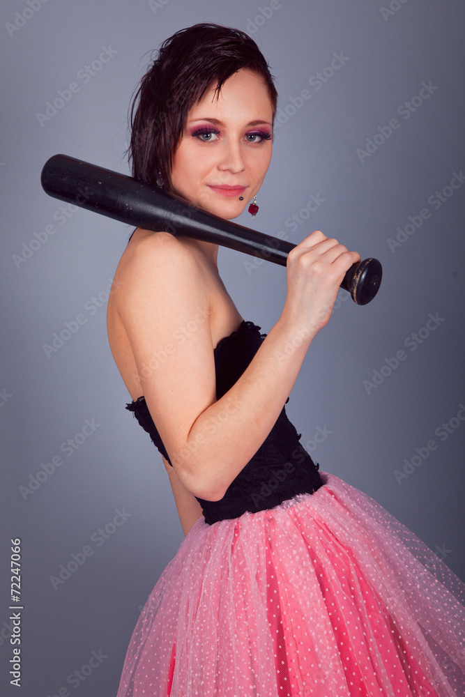Elegant brunette girl with a baseball bat in his hands Elegant brunette girl with a baseball bat in his hands