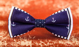 blue bow tie with a pattern of marine anchors