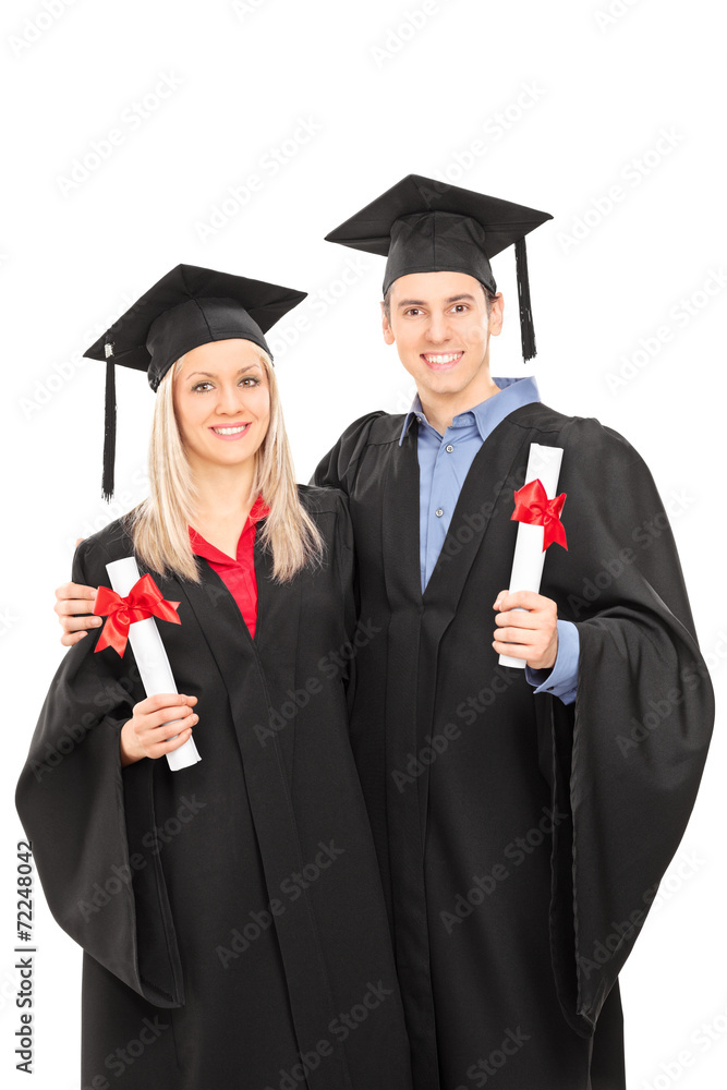 Man and woman in graduation gowns holding diplomas Man and woman in graduation gowns holding diplomas
