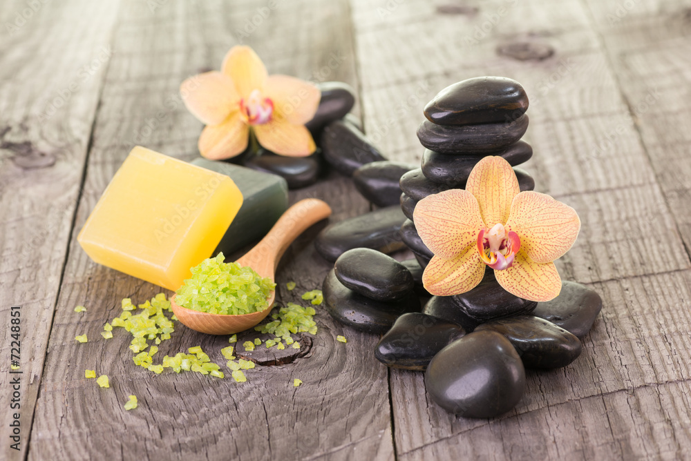Yellow Moth orchids and black stones on weathered deck Yellow Moth orchids and black stones on weathered deck