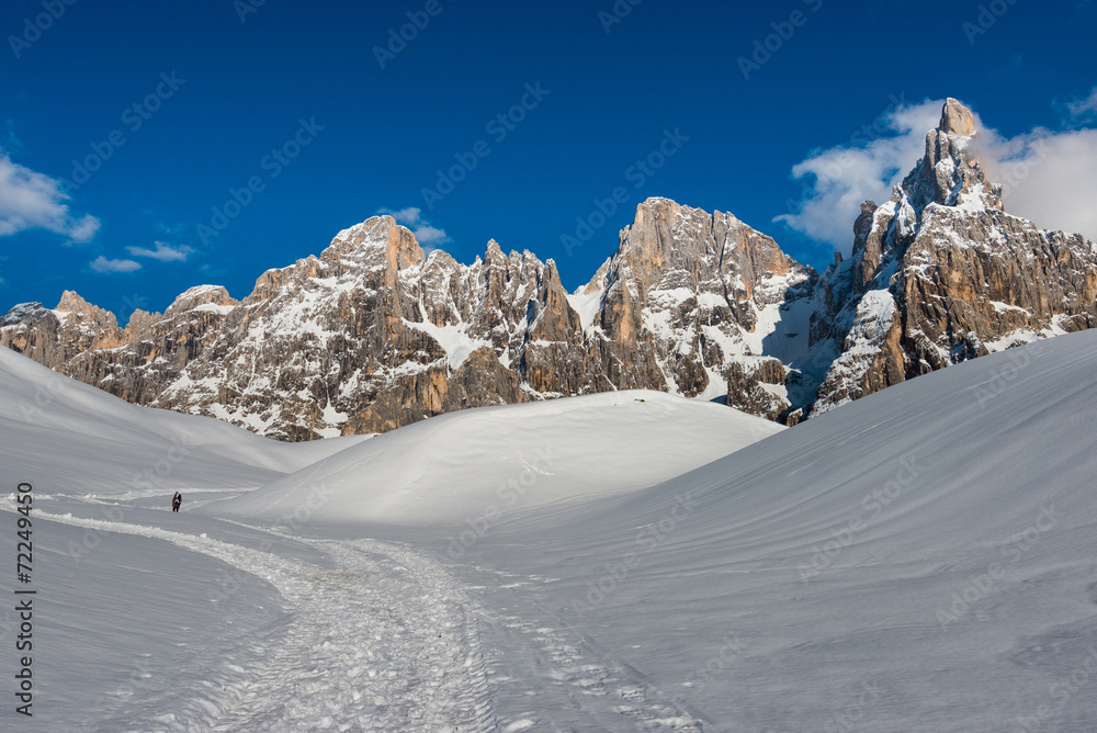 Hiker heading the Pale mountains in the snow, Dolomites