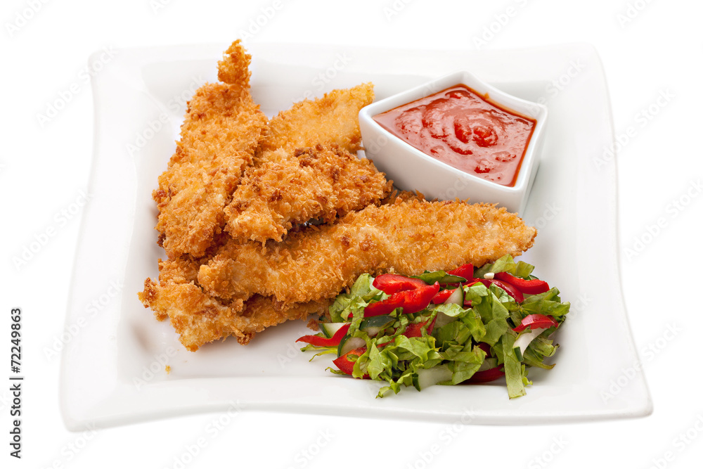 Fried chicken breast fillet in batter with vegetable salad on th Fried chicken breast fillet in batter with vegetable salad on th