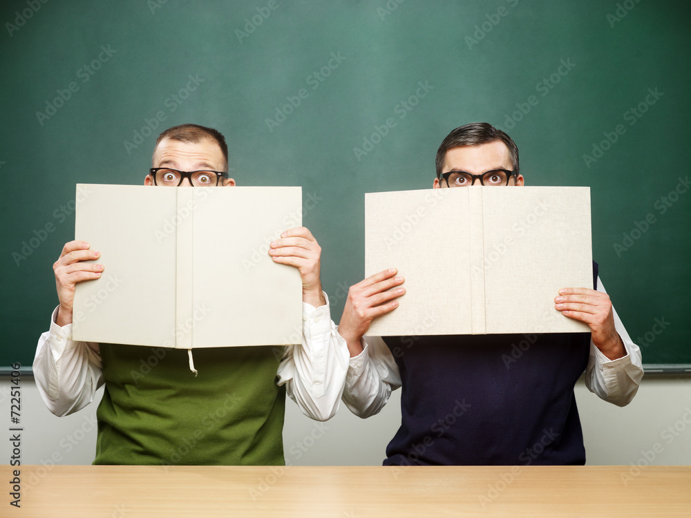 Two male nerds holding books Two male nerds holding books