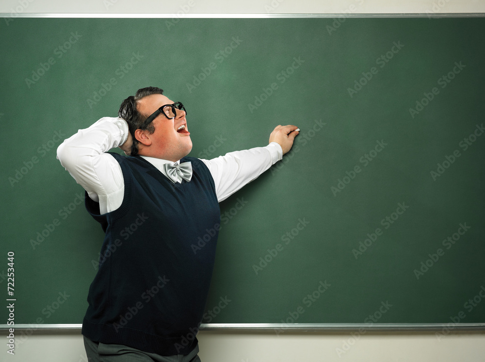 Male nerd in extasy in front of blackboard